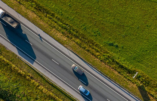 Truck and two passenger cars on the road